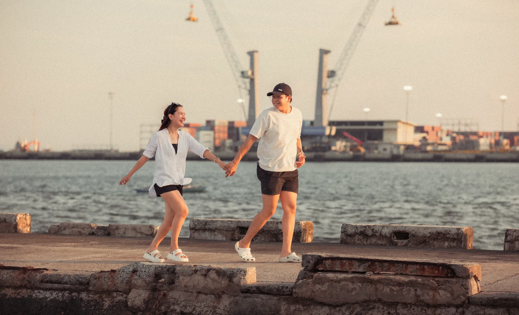 Geocel and Myles walking hand in hand along Cebu Harbor